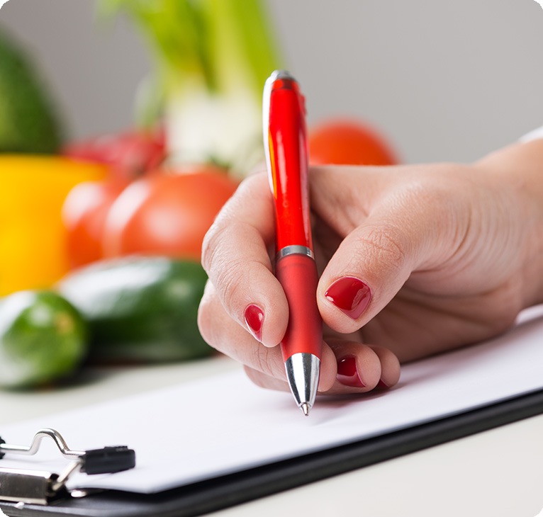 Dietitian Writing On Clipboard | Lifepath Dietitian | Lifepath Wellness & Dental